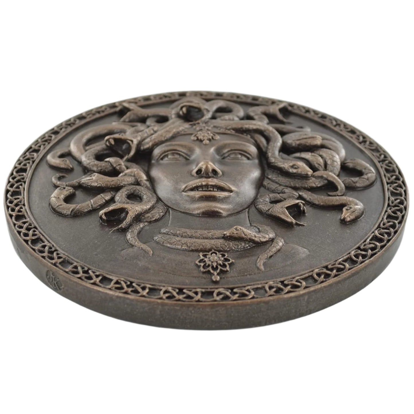 Decorative plaque with Medusa design on a white background