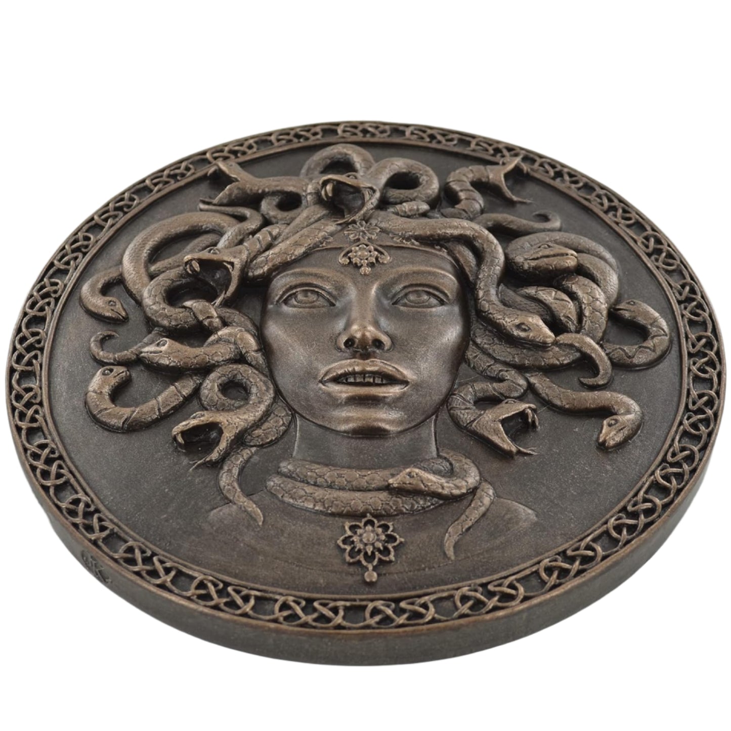 Decorative plaque with Medusa's head design on a white background