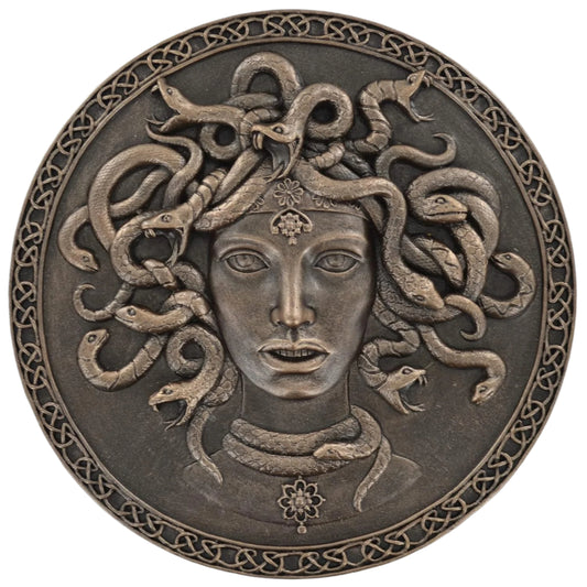 Bronze plaque of Medusa with snakes on a white background