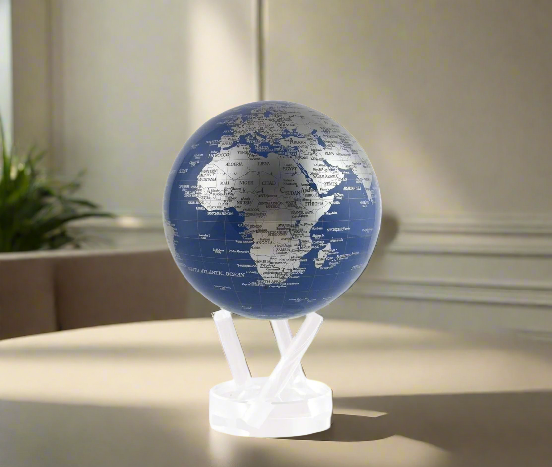 MOVA Blue & Silver 4.5 inch globe on a 3 prong stand on a table