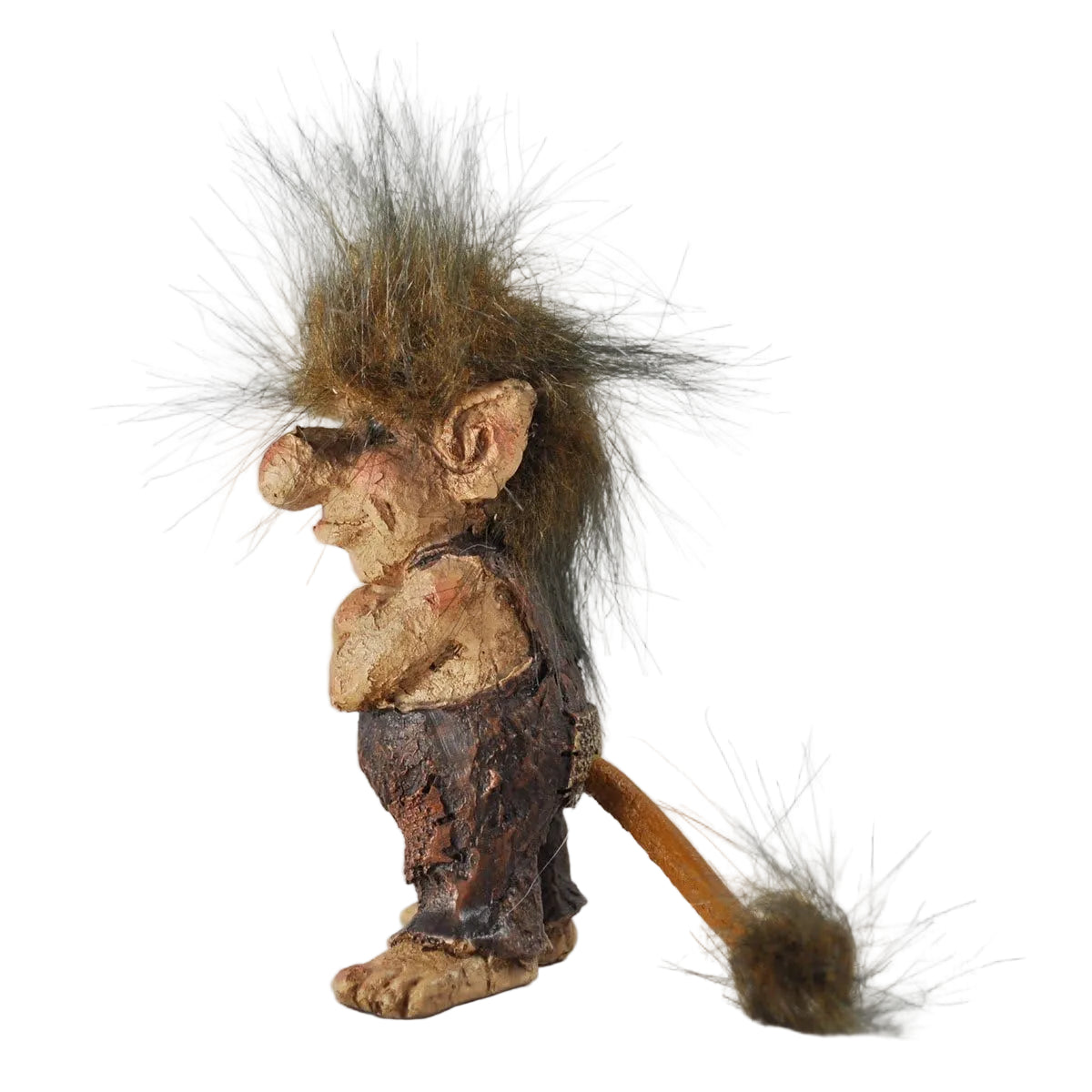 Small troll in dungarees with a bushy tail and hair
