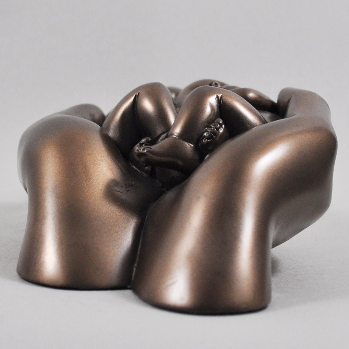 Twin babies in hands In Cold Cast Bronze