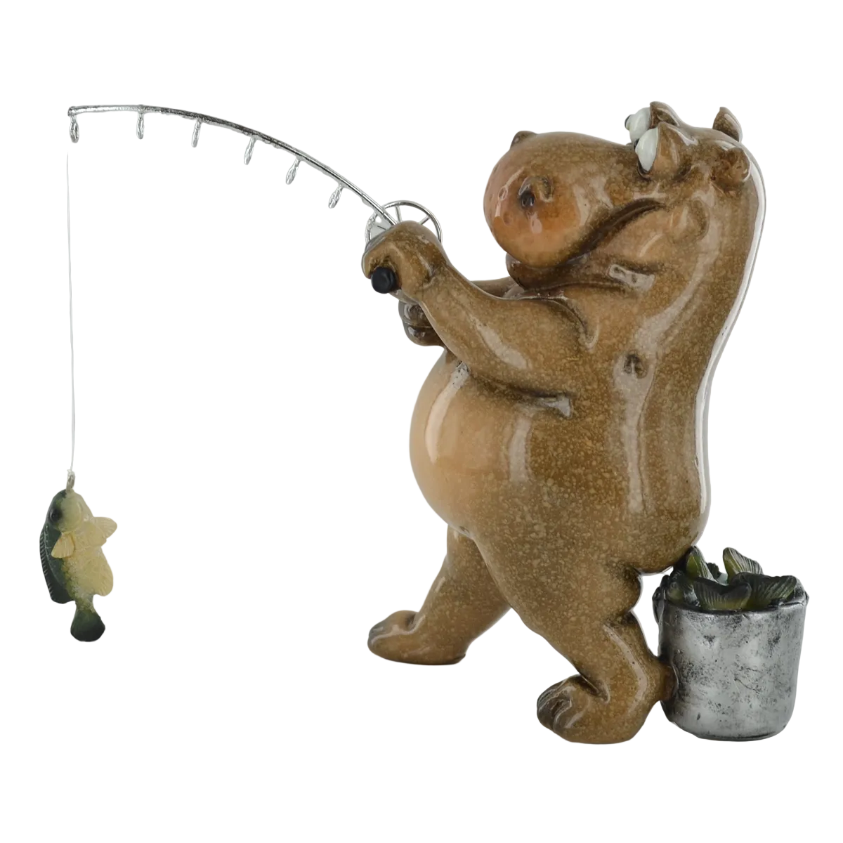 A ceramic figurine of a hippo fishing, holding a silver-finished rod with a dangling fish, set against a plain light gray background.