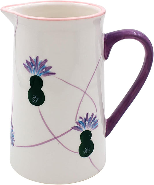 A white ceramic pitcher with a purple handle, pink rim, and floral thistle designs on the side.