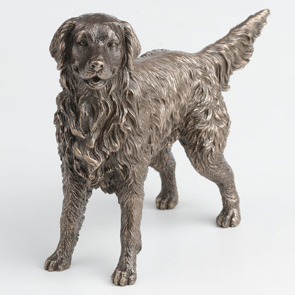 Bronze statue of a retriever dog on a white background