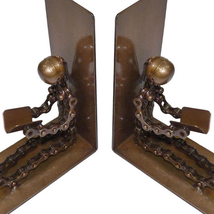A pair of decorative metal bookends shaped like seated figures made from bicycle chains and spherical elements, shown on a plain white background.