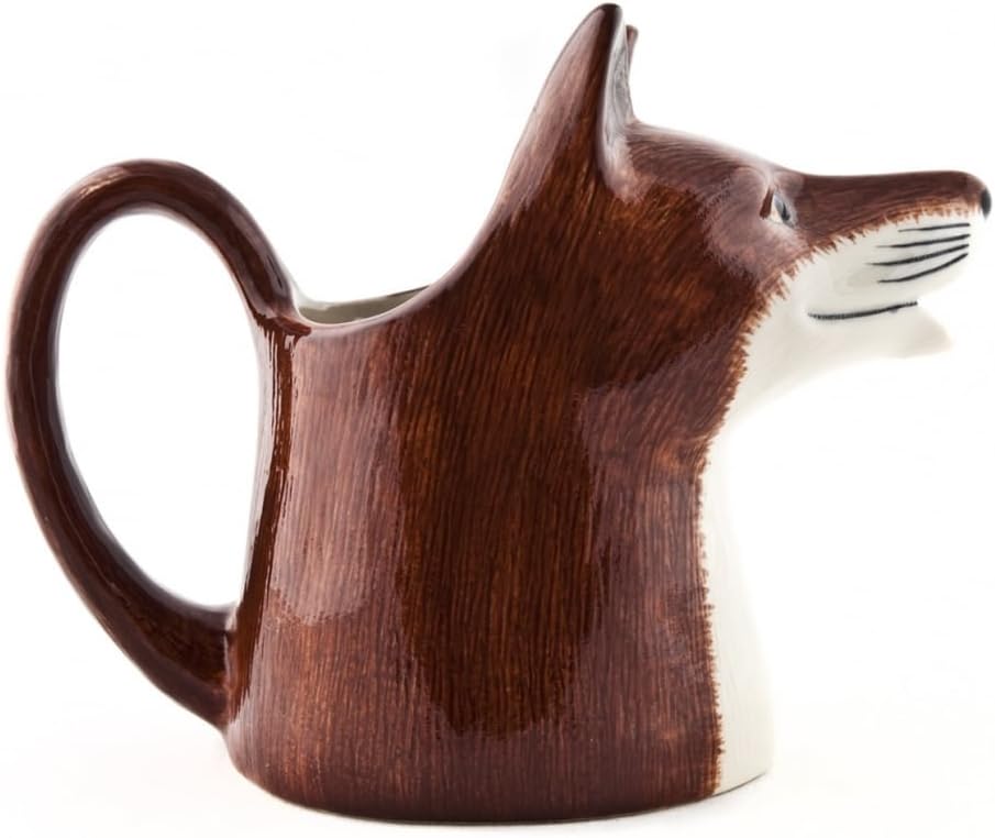 A ceramic pitcher shaped like a fox head, featuring a glossy dark brown body with a white muzzle and black whisker details, set against a plain white background.