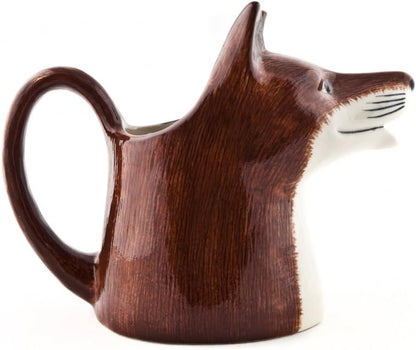 A ceramic pitcher shaped like a fox head, featuring a glossy dark brown body with a white muzzle and black whisker details, set against a plain white background.