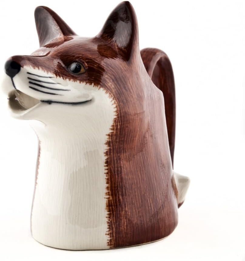 A ceramic fox-shaped pitcher with a brown and white glaze, featuring a handle on the back and a small spout on the front, set against a plain white background.