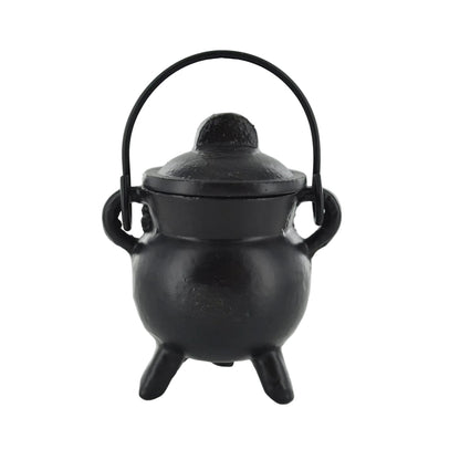 Black cast iron cauldron with lid on a white background