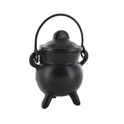Black cast iron cauldron with lid on a white background
