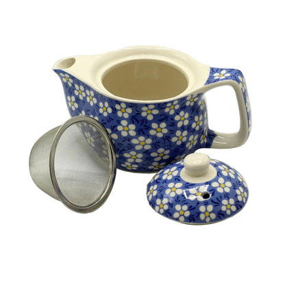 Ceramic teapot with floral pattern, mesh filter, and lid on a white background