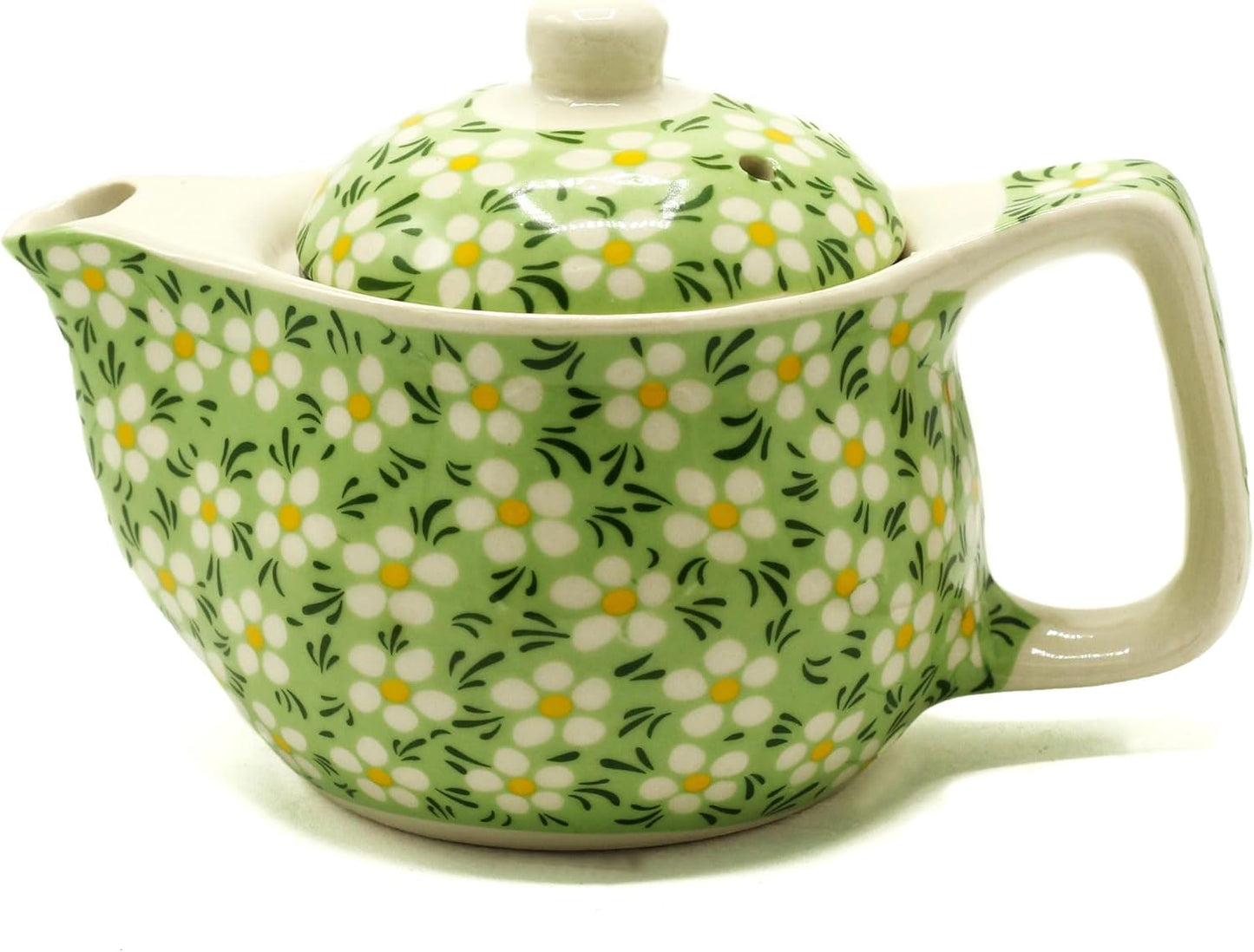 Green ceramic teapot with floral pattern on a white background