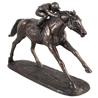Bronze statue of a horse and jockey in motion on a white background