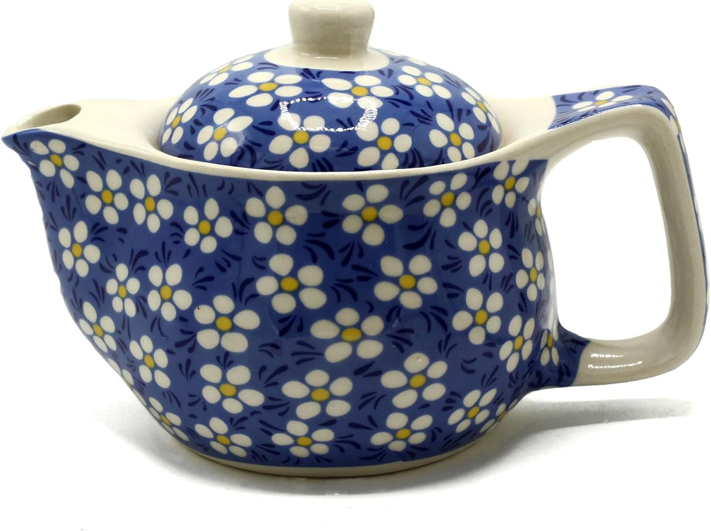 Ceramic teapot with floral pattern on a white background