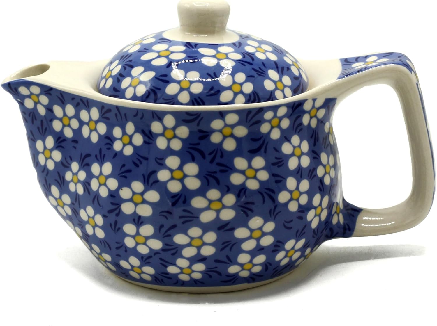 Ceramic teapot with floral pattern on a white background