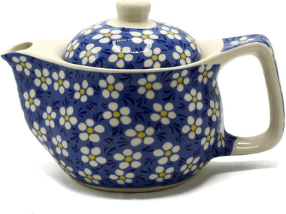 Ceramic teapot with floral pattern on a white background