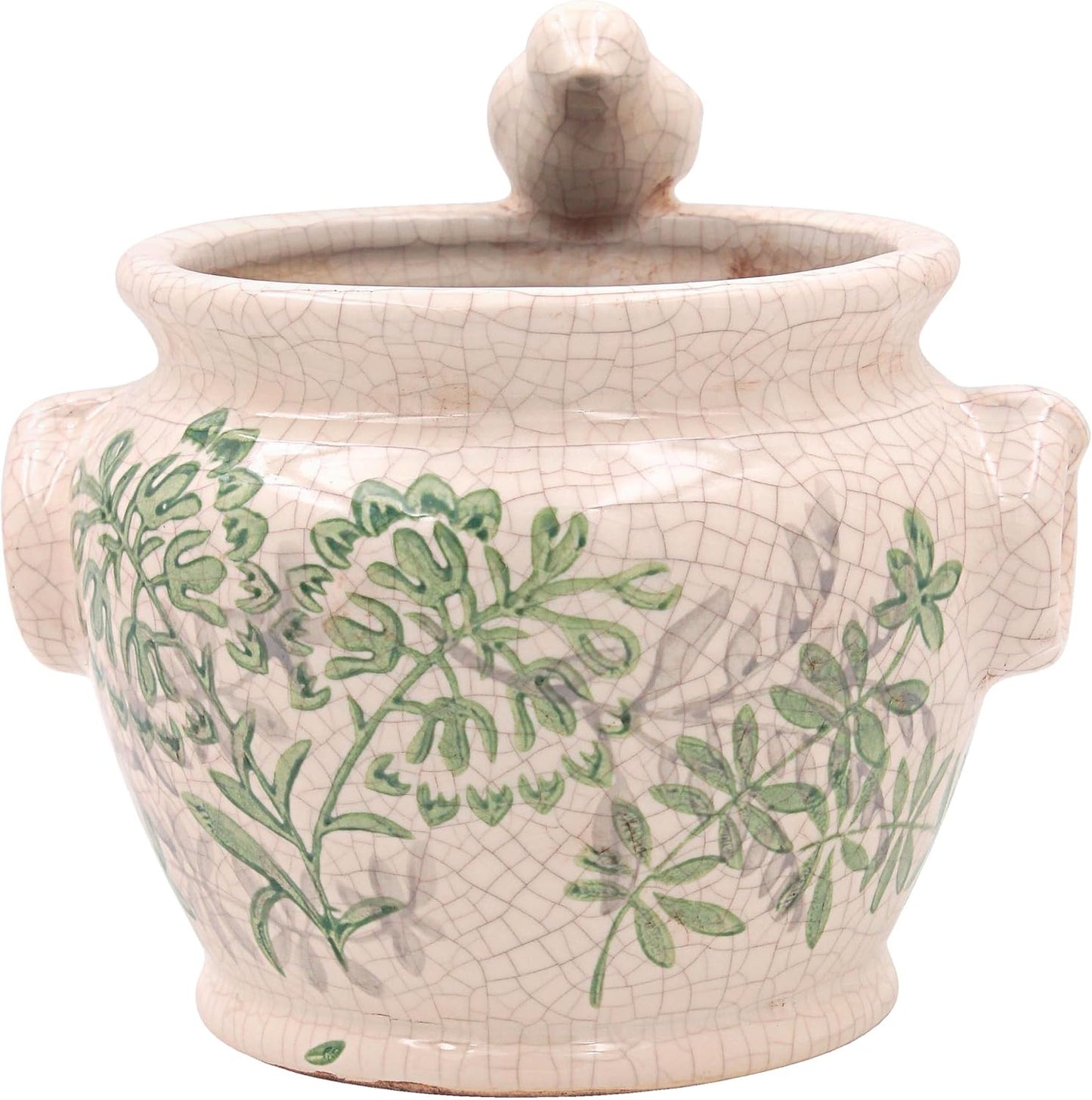 A ceramic lidded jar with a crackle glaze in a warm off-white tone, decorated with green botanical leaf patterns and featuring side handles and a bird on the rim.