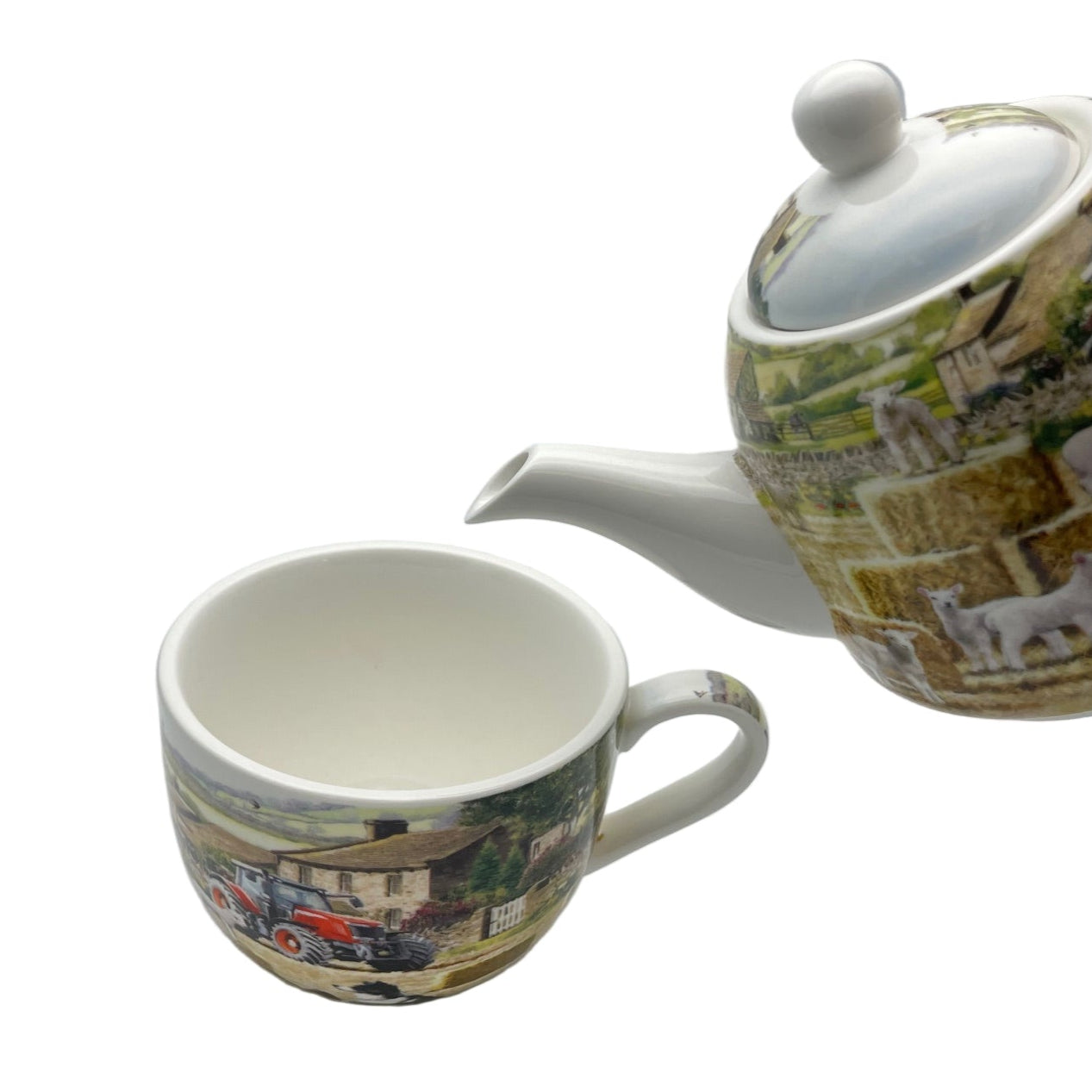 Teapot and mug with scenic design on a white background