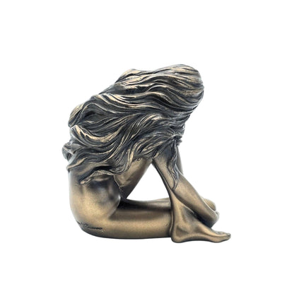 Bronze sculpture of a woman with flowing hair on a white background