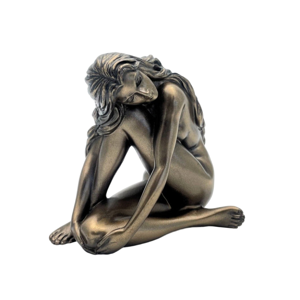 Bronze statue of a nude figure on a white background