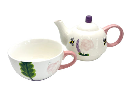 Ceramic teapot and cup with floral designs on a white background