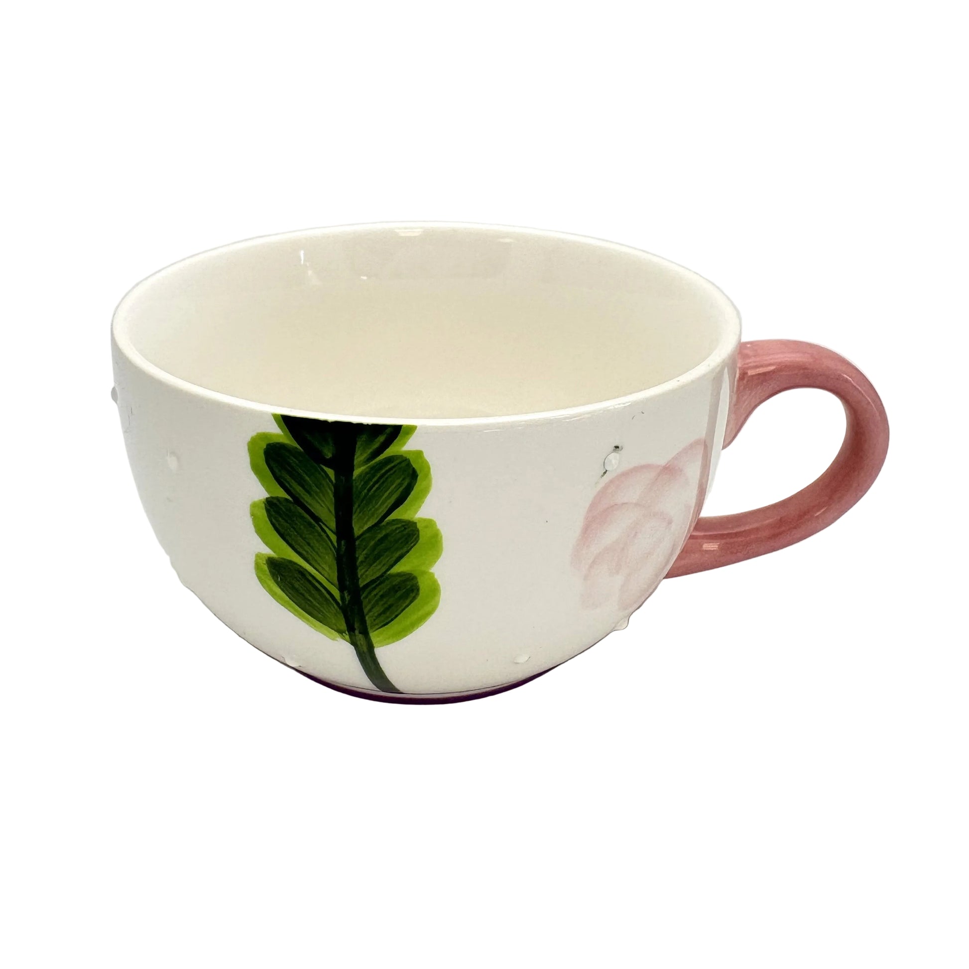 Ceramic mug with green leaf design on a white background