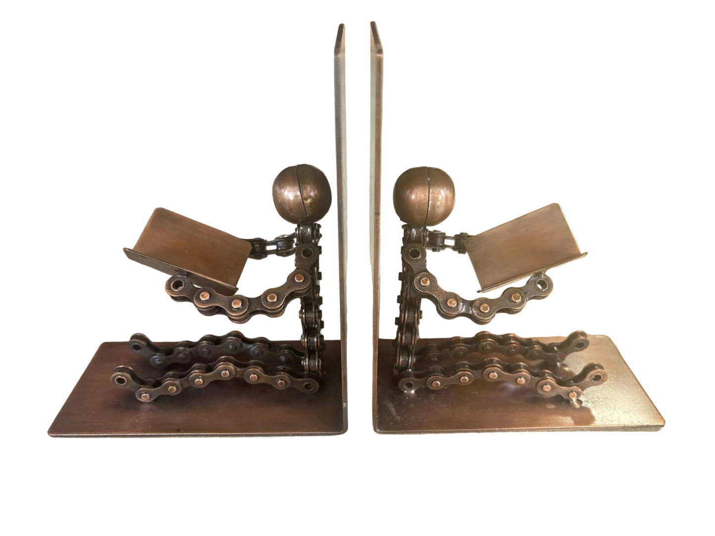 A pair of decorative bookends shaped like figures feading from bike chains