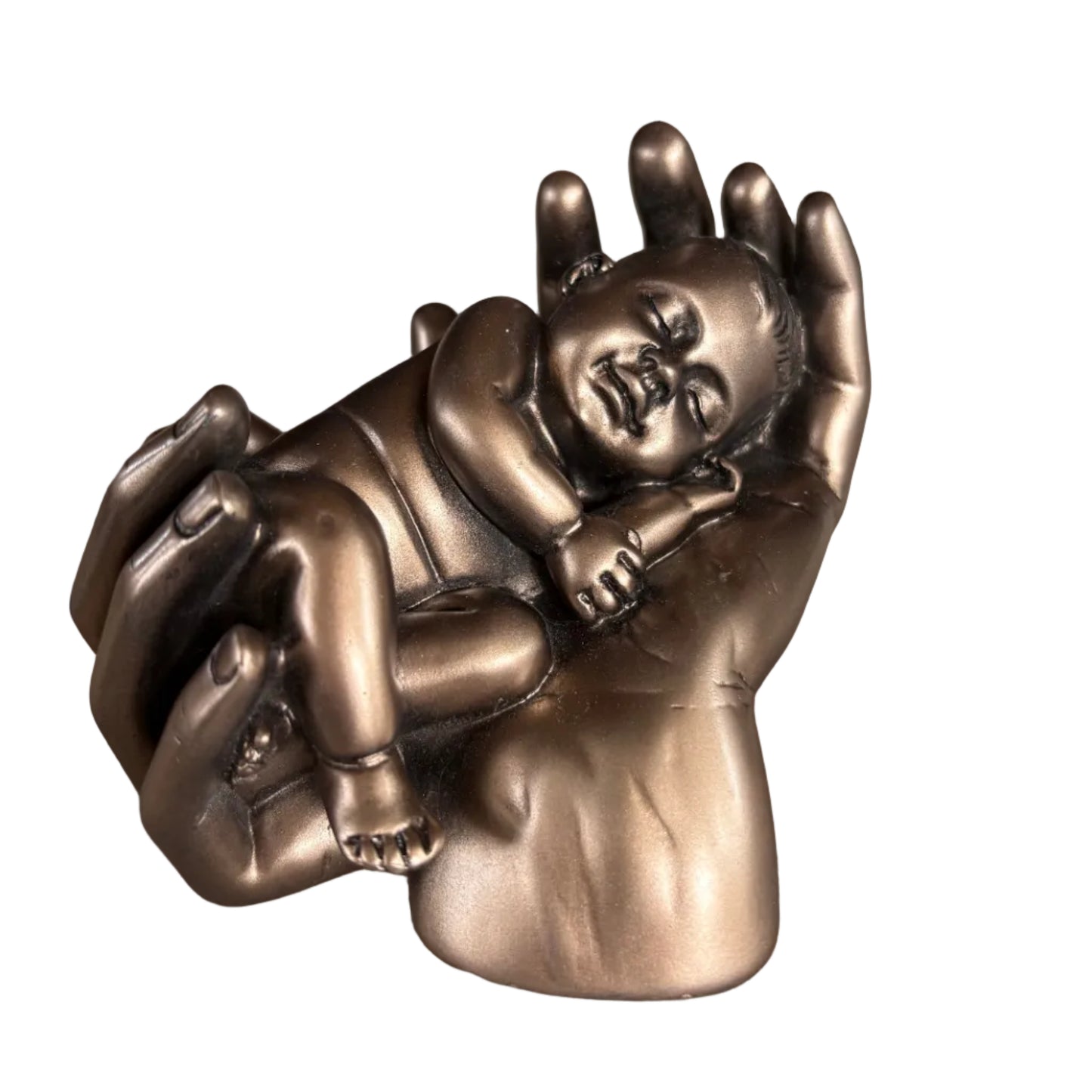 A metallic bronze wall-mounted sculpture depicting a baby nestled in a mother's hands, mounted on a textured gray wall.