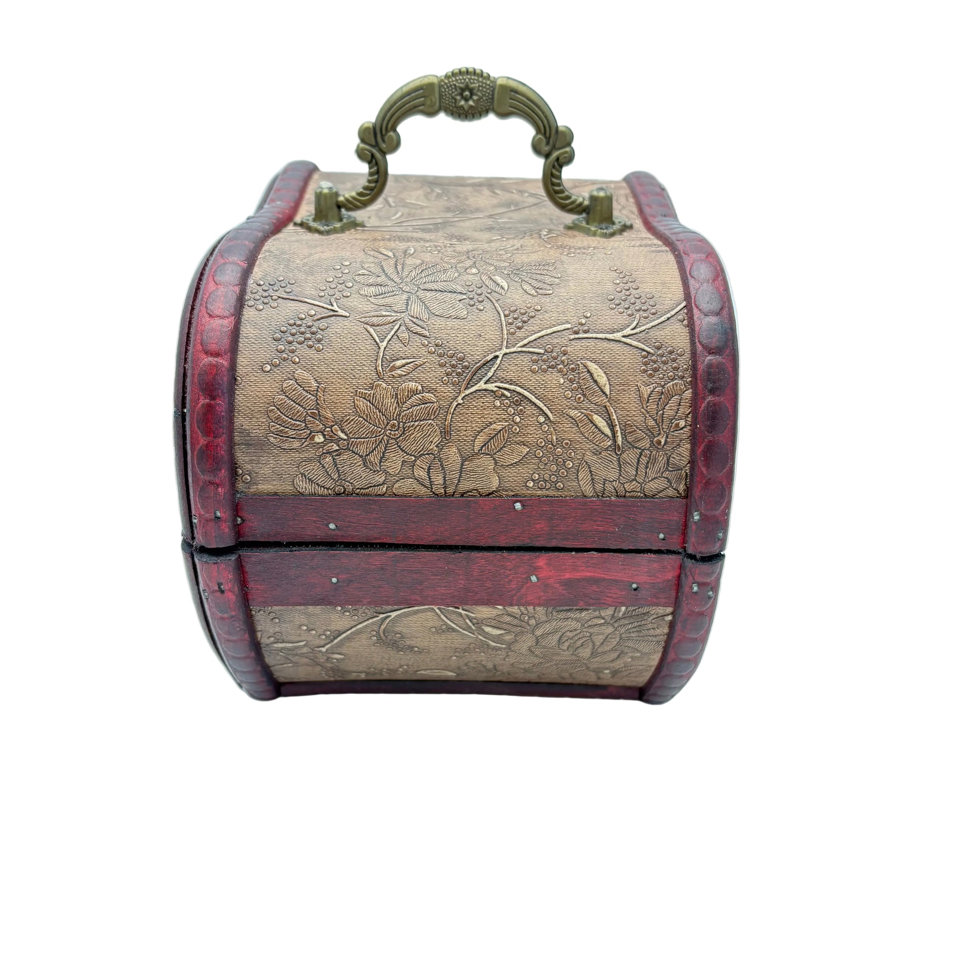 A vintage-style decorative box with a curved top handle, featuring a beige floral embossed center panel, dark red sides, and antique brass hardware on a light blue background.