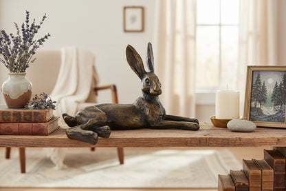 Bronze hare figurine on a white background