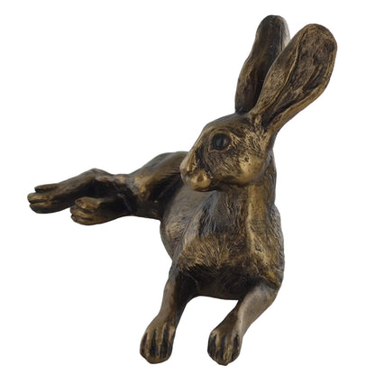 Bronze rabbit figurine on a white background
