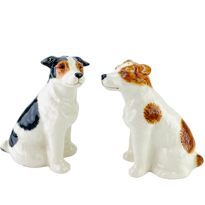 Two ceramic Jack russell dog figurines on a white background
