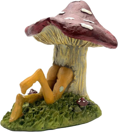 Pixie figurine sitting through a mushroom with a white background
