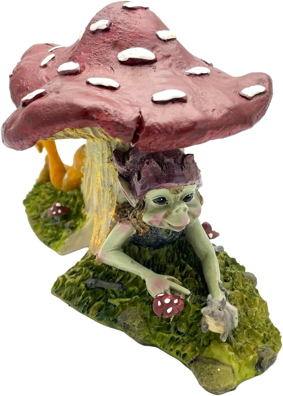 Pixie figurine under a red mushroom on a white background